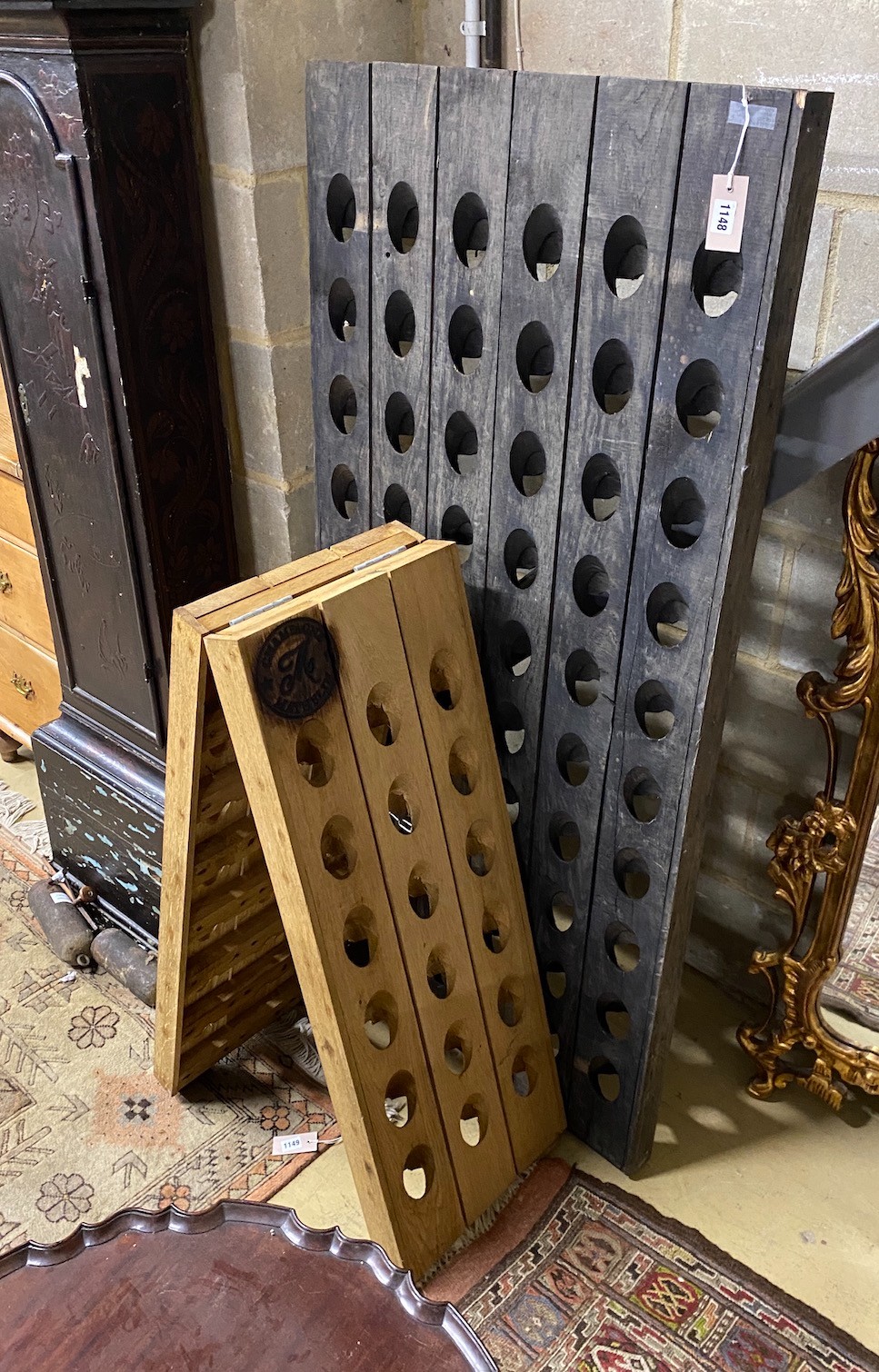 Two Riddling racks (champagne bottle holders), one A framed with branded Mathelin crest, combined capacity 96 bottles, larger 152 cm high.